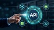 © Ahmed - Application programming interface cloud software integration concept with executive hand pressing API glowing hologram button in data center