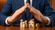 © Depot - Businessman hands making roof shape over wooden family house and coin stacks representing life insurance and wealth protection