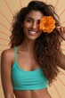 © Iryna - Smiling woman portrait with orange flower over eye against sunray backdrop for beauty banner background and summer lifestyle design