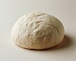 © BYAI - Round, uncooked dough ball resting on a plain surface.
