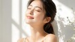 © Diclonius - A beautiful young woman with closed eyes basks in the gentle sunlight, her face tilted upwards in serene contentment. Soft light and shadow patterns create an artistic and peaceful ambiance.