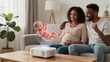 © YiuCheung - Pregnant couple smiles as projector shows 3D baby model in cozy living room.