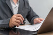 © NongAsimo - Risk and Financial Security Concept, Businessman Review Insurance Documents, Checking Coverage Terms with Pen, Policy Benefits Verification, Insurance Protection, Claim Eligibility, Contract Review