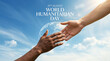 © GOPALCHANDRO - World humanitarian day concept with human hands reaching toward a glowing earth against blue sky