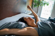 © Davor - Woman stretching in bed on a sunny morning at home