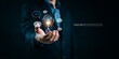 © Aonjona Arts - Business professional holding light bulb with artificial intelligence brain and command prompt.