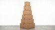 © Marin Studio - Stack of cardboard boxes of various sizes on a concrete floor