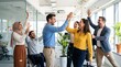 © Rafli - Diverse group of happy business colleagues celebrating success with confetti in modern office.