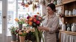 © firdol - Professional Female Florist Arranging Vibrant Bouquet of Roses and Eucalyptus in Rustic Flower Shop