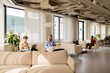 © Artem Podrez/Stocksy - People using laptops and smartphone in modern office coworking space
