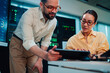 © Zamrznuti tonovi - It professionals analyzing data on a digital tablet in a server room, collaborating on network security and maintenance