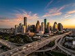 © Farvez - Aerial view of the modern downtown houston skyline with highway traffic during a beautiful golden hour sunset
