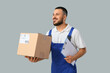 © Pixel-Shot - Delivery man with parcel and clipboard on light background