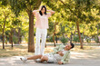 © Pixel-Shot - Young woman calling ambulance for man having heart attack in park