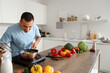 © Pixel-Shot - Young man frying vegetables at table in kitchen