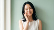 © Arslan - Happy Japanese woman touching her face. Natural beauty portrait of a smiling young lady.