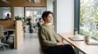 © Segati - Woman meditating in a modern office near a large window