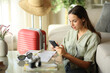 © PheelingsMedia - Serious tourist using phone during vacation in apartment