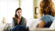 © tashechka - Two women talk in a bright living room during a conversation about personal issues on a sunny day