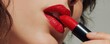 © Nart - A bold red lipstick is applied to detailed, glossy lips on flawless skin. This high-end cosmetic shot highlights beauty and the premium makeup advertising aesthetic.