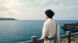 © minaduchi - 海辺の柵に佇み静かに海を見つめる20代男性の後ろ姿 ｜ 広い水平線