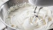 © Galina Petrova - Whipped cream being mixed in a stainless steel bowl with mixer