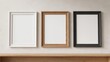 © tan - Three empty picture frames hanging on a wall.