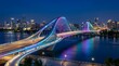 © Trendy Graphics - Modern arched bridge with colorful rainbow led lighting at night