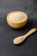 © reddish - Wooden bowl and spoon filled with quinoa seeds