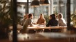 © Aisha - Professional meeting in a bright clean cafe, diverse group reviewing papers and notes, realistic textures, shallow depth of field
