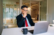 © DZ FILM/Stocksy - A man using a laptop in the office
