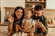 © La Famiglia - Happy family baking cupcakes in modern kitchen