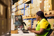 © DC Studio - African American warehouse employee speaks with a manager on a video call, sharing parcel status and order tracking details through customer support while resolving an e-commerce shipment mix-up.
