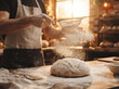 © Fernando Sanso - Professional baker dusting white flour over fresh dough in a warm rustic bakery kitchen