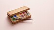 © ROKANI - A wooden watercolor paint set with a brush in a studio art workspace setting