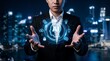 © Norah Allen - A businessman in a dark suit holds his hands out while glowing artificial intelligence holograms float in front of him against a blurred night city lights bokeh backdrop technology