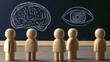 © Jack - Wooden figurines look at the chalkboard with a brain and an eye, serving as symbols for thought and perception.