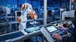 © Lee - Factory operator using control panel to manage KUKA robotic arm assembling electronics on production line, showcasing human machine collaboration in advanced industrial automation