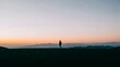 © Kitta Studio - Person Standing on Hilltop Watching Sunset Sky and Mountain Range at Dusk