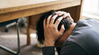 © Maksym - Man shielding head under wooden table during earthquake or crisis