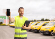 © Ljupco Smokovski - Man in a reflective vest holding a clipboard and a smartphone