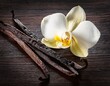 © Milla - aromatic vanilla beans and delicate blossom on dark wood