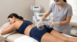 © Fiverr/fazilazia703 - Experienced aesthetician performing non-invasive vacuum therapy butt lift treatment on a young woman's glutes in a modern, sterile medical spa clinic, enhancing body contouring and skin elasticity.