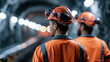 © Kateryna - Rear view of european workers in helmets with headlamps working inside a bright coal mining gallery clean conveyor structure and tidy supports along pale rock walls under even