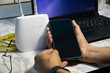 © tanit - The man is using a smartphone and router, high-speed internet connection, network bandwidth technology, and speed optimization.