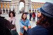 © Marko Geber - Friends laughing and holding hands at praca do comercio, lisbon, portugal