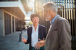 © Davor - Business colleagues discussing strategy outside modern office