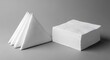 © HariBudi - Stack of white paper napkins and folded triangular serviettes isolated
