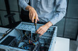 © Wanda - Asian IT engineer using screwdriver fix pc case