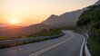 © MSTMAYA - Winding asphalt road through a mountainous landscape at sunset with guardrails and dramatic golden light hitting the peaks and green hillsides